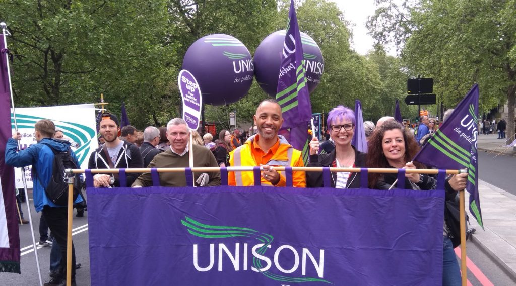 Tim and UNISON colleagues hold a banner on a demonstration