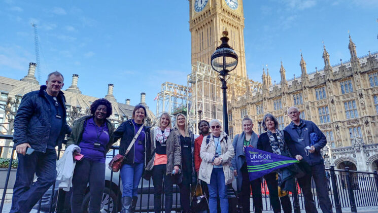A group of care workers standing outside parliament