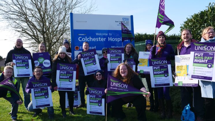 A group of health workers outside Colchester Hospital with signs saying Put NHS Pay Right