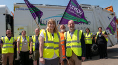 UNISON's Isabel stands with Cllr Hassall in front of Hunts DC workers and a refuse lorry