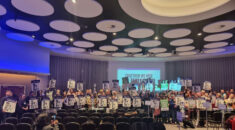 Delegates to UNISON Higher Education conference hold placards reading 'No cuts at UEA'