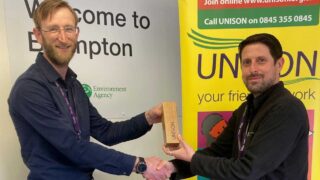 Chris Swain on the left receives his award from branch comms officer James Chrisp