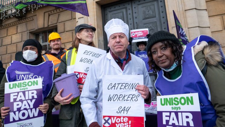 People in different work outfits campaigning for a pay rise