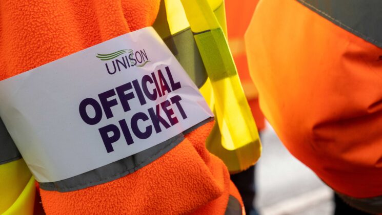 A person wearing a UNISON official picket armband