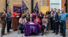 A group of UNISON reps and probation workers hold up anti-racism pledge cards