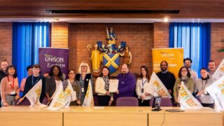A group of people pose to celebrate signing UNISON's Anti-Racism Charter