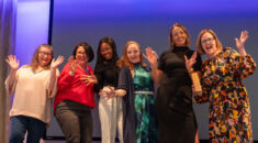 Norfolk Community Health celebrate their award with jazz hands