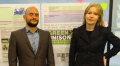 Gareth and Katie stand by a sign celebrating UNISON Green Week