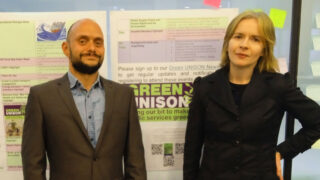 Gareth and Katie stand by a sign celebrating UNISON Green Week
