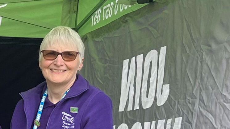 Helen smiles in a UNISON gazebo