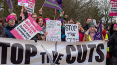 People hold signs opposing cuts at the University of Essex